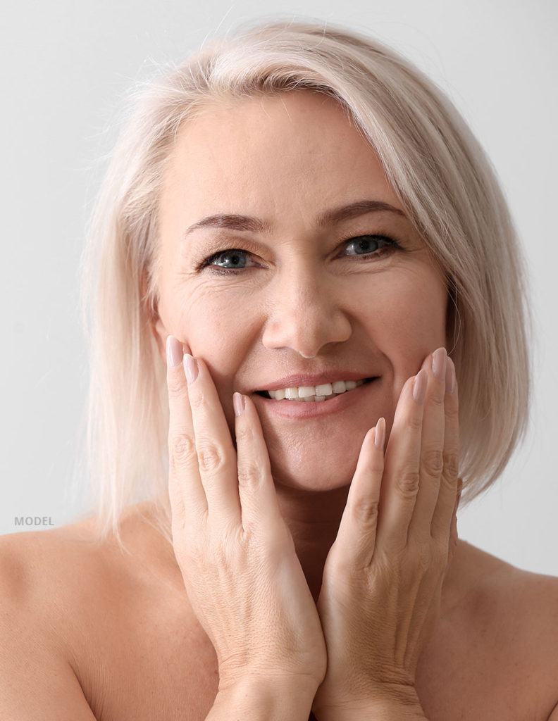 woman holding her face with her hands, 