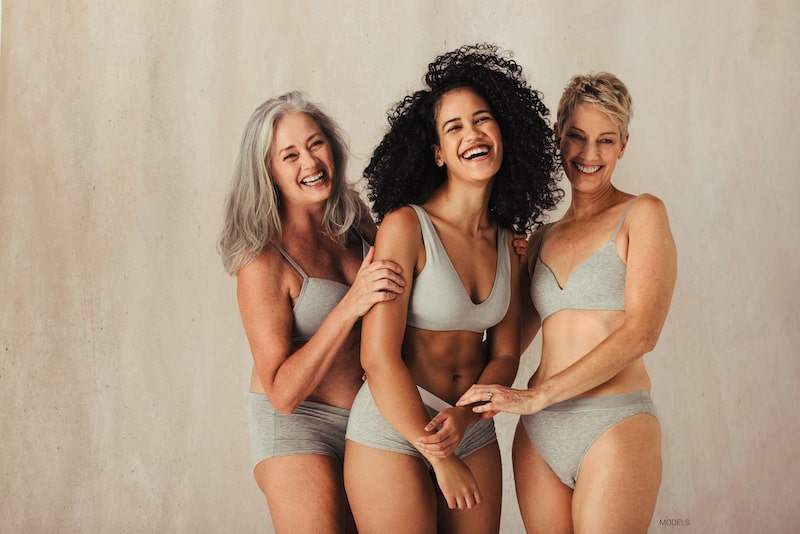 Three woman wearing gray underwear in studio.