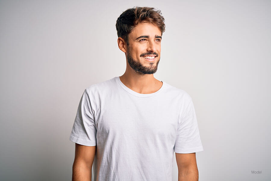 Young man in a lose fitting white tshirt