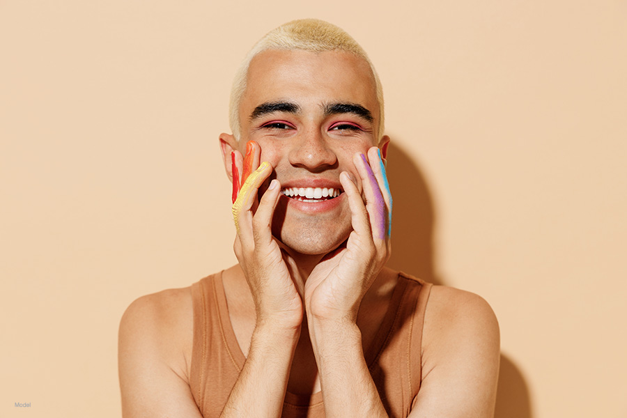 a person with rainbow's painted on their fingers