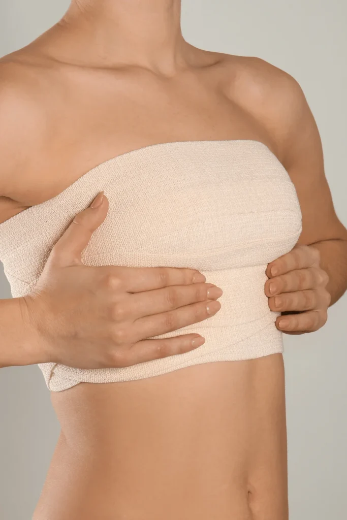 taped breasts portraying how long after breast reduction will i know my size​