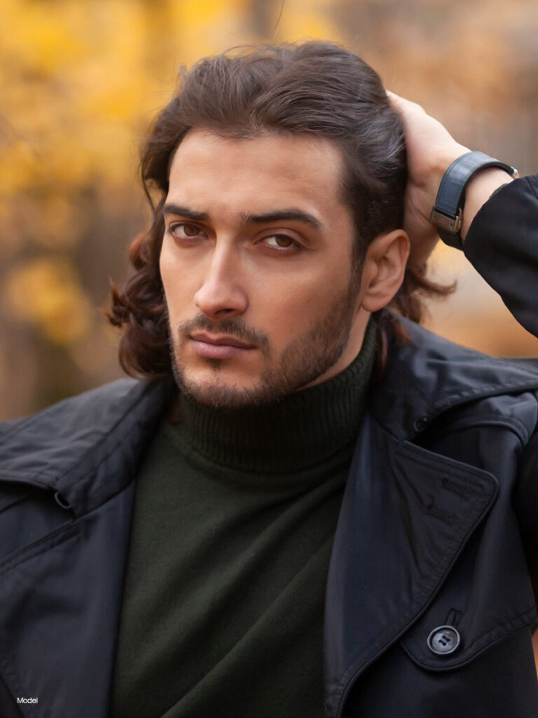 Man pushing his hair back with his hands