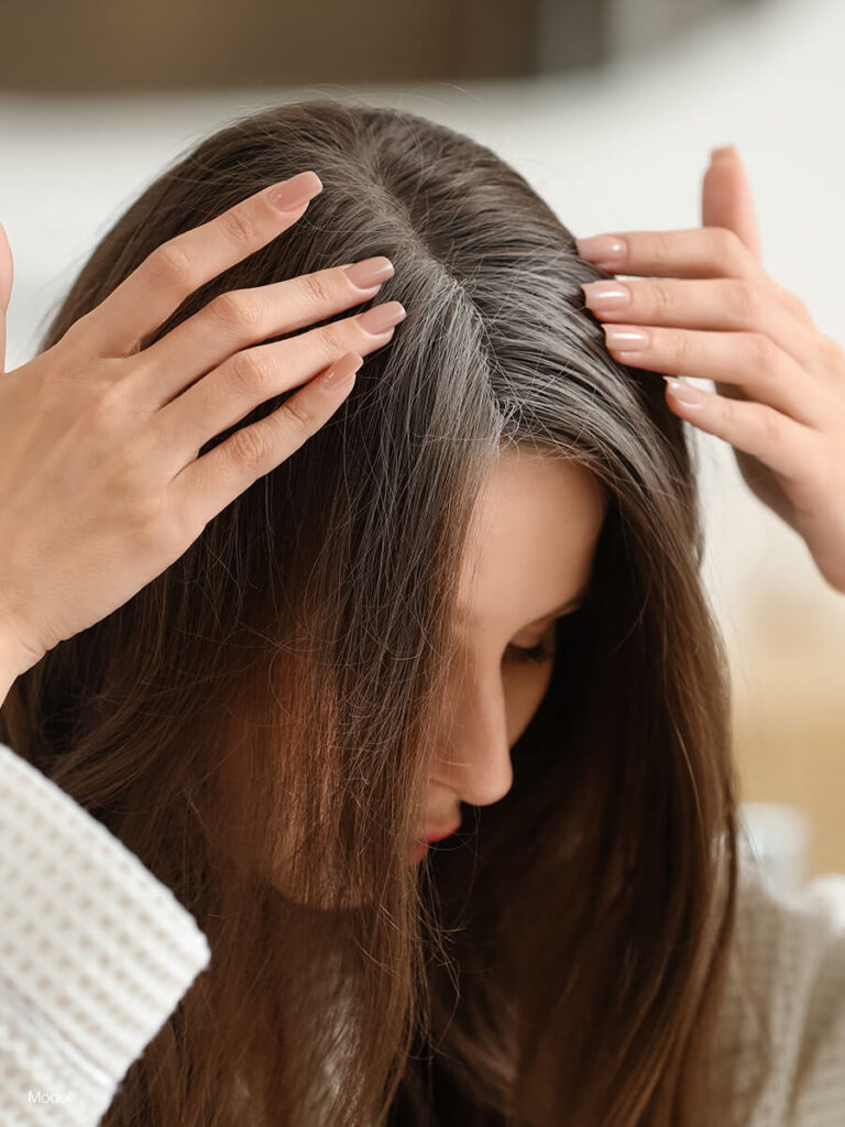 A woman parting her hair