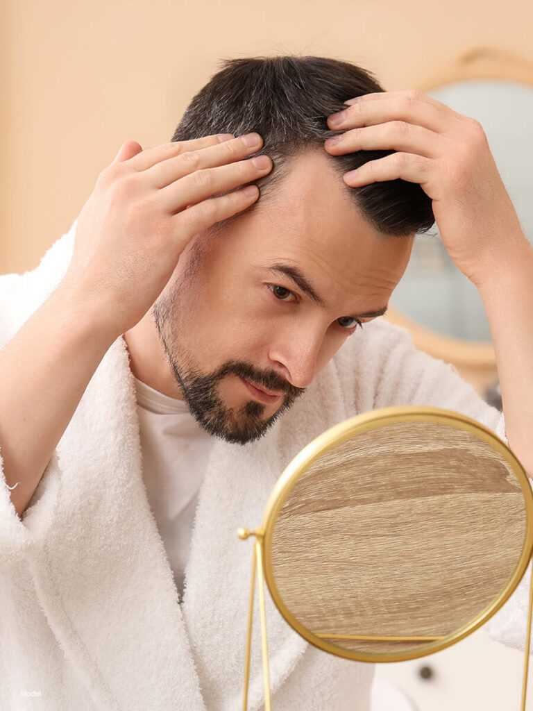 a man looking at himself in the mirror