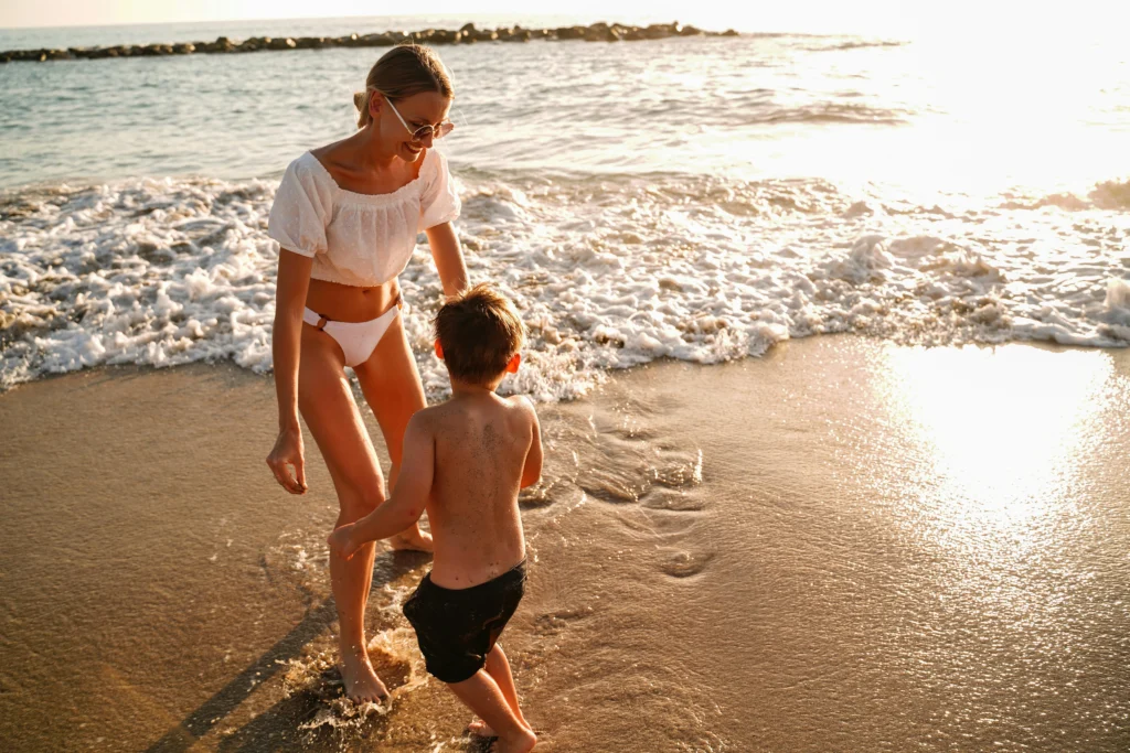 Woman at the beach with a child 
