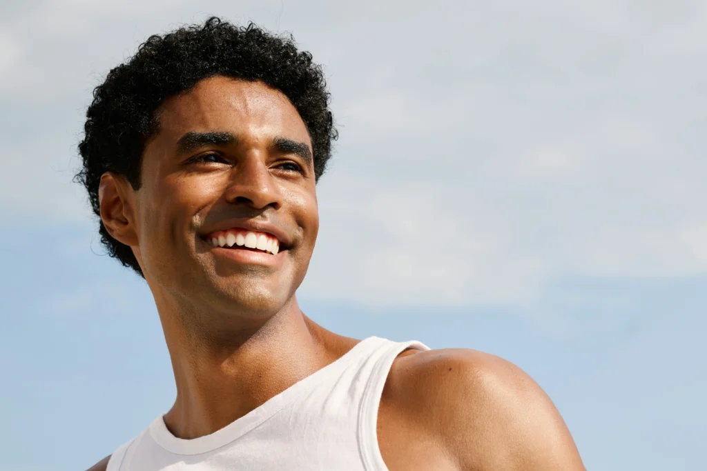 image of smiling man with thick natural hair after hair restoration treatment