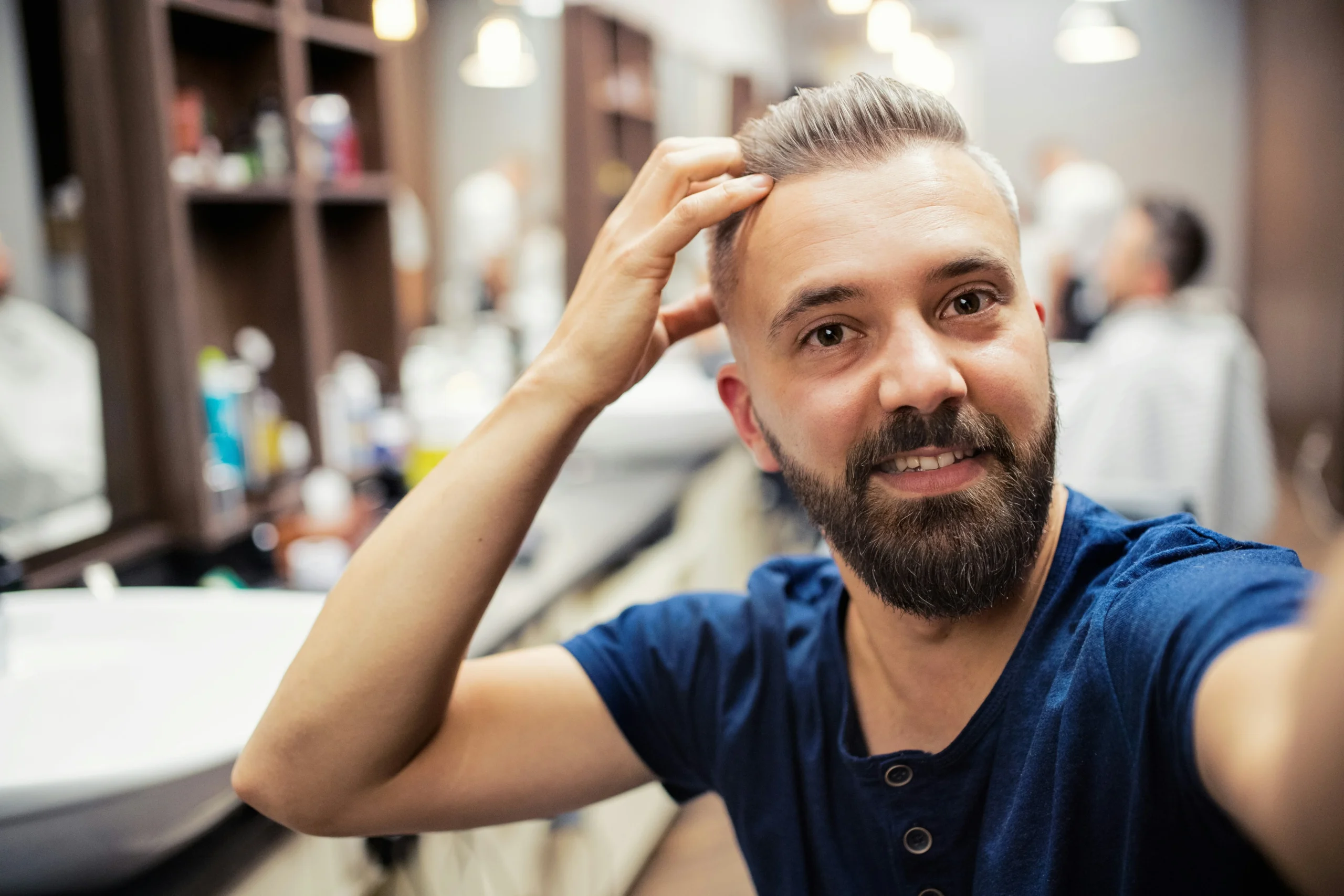 Image of a confident man with full hair in a barbershop setting