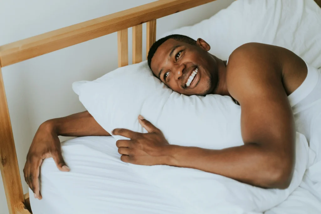 Image of man resting comfortably in bed during hair transplant recovery