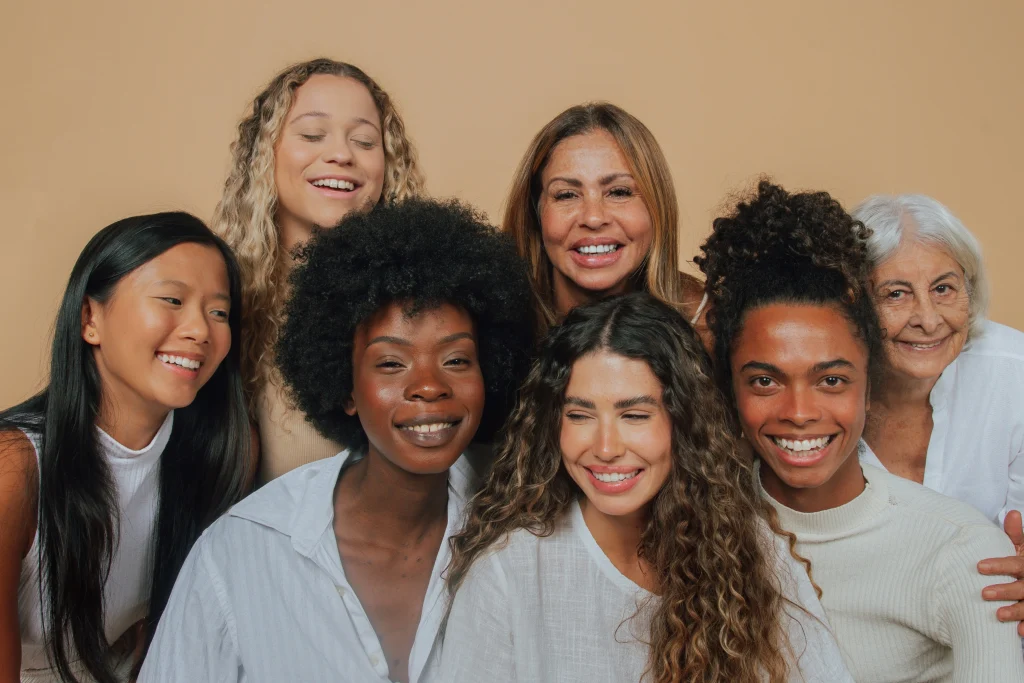 Image of group of diverse women smiling confidently after labiaplasty